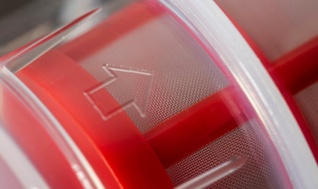 Transparent automotive fine fuel filter on a gray backgroundの写真素材