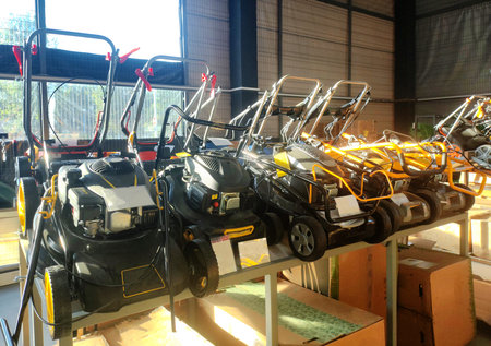 Sale of modern petrol mowers in a petrol equipment store against the background of a window, indoorsの写真素材