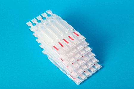 Tubes with medicine on a blue background. Concept of a laxative for the treatment of constipation in...