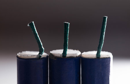 Three blue firecrackers with a wick, close-up. Safety concept for pyrotechnic explosions, macroの写真素材