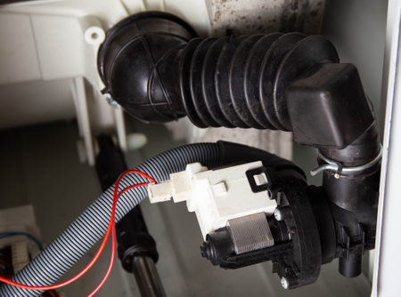 Damage and replacement of the washing machine drain pump.の写真素材