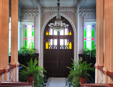 Antique room with a door with columns and plants inside with multi-colored glass, indoorsの写真素材