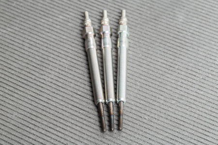 Modern rod ceramic glow plugs for easier starting of a diesel engine in cold weather on a gray background. Automotive spare part, heating element, engine preheaterの写真素材