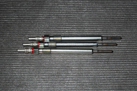 Modern rod ceramic glow plugs for easier starting of a diesel engine in cold weather on a gray background. Automotive spare part, heating element, engine preheaterの写真素材