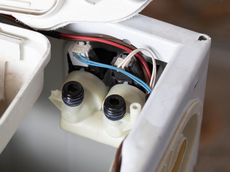 replacing water supply valves in a washing machineの写真素材