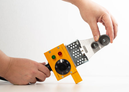 Replacing nozzles on a plumbing electric soldering iron on a white background, isolate.