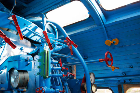 Control panel of an old steam locomotive inside with gauges and pressure gauges