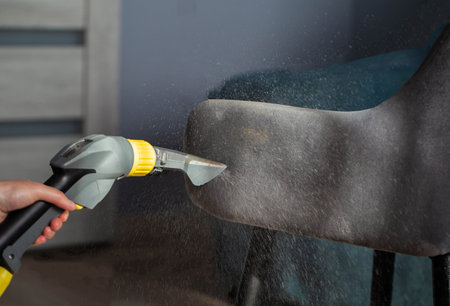 Dry cleaning services, washing and cleaning gray fabric chairs with a washing vacuum cleaner. Copy space for textの写真素材
