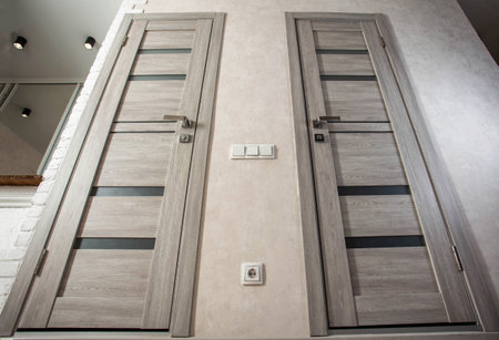 Modern gray interior doors in the hallway for the entrance to the toilet and bathroom, styling