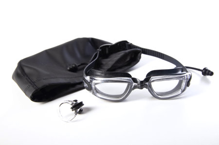 Swimming goggles and swimming cap with nose clip on white background, isolateの写真素材