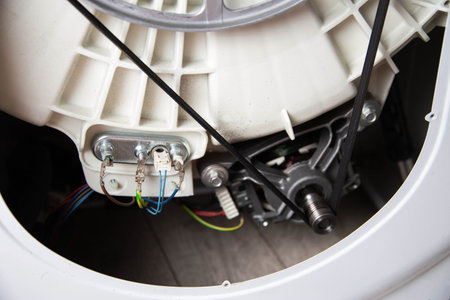 Weak belt tension on the washing machine motor pulley, damage to the washing machine.の写真素材