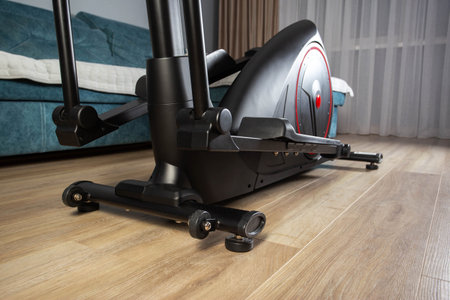 Modern Elliptical Trainer in the Room at Home. Concept of Exercising at Homeの写真素材