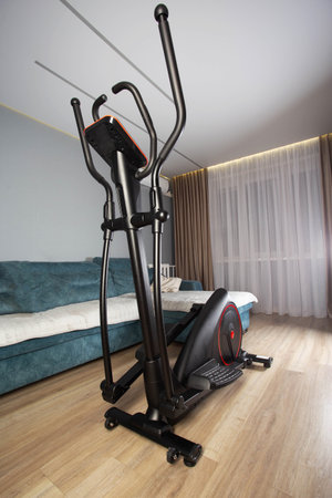 New modern elliptical trainer at home in the exercise room