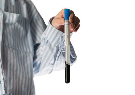the girl's hand holds a test tube with sputum on a white background, close-up. Concept for studying...