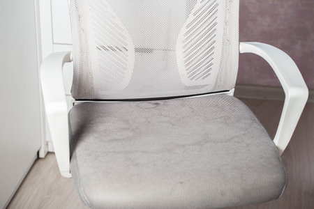 Dirty gray computer chair with stains on upholstery fabric, dry cleaningの写真素材