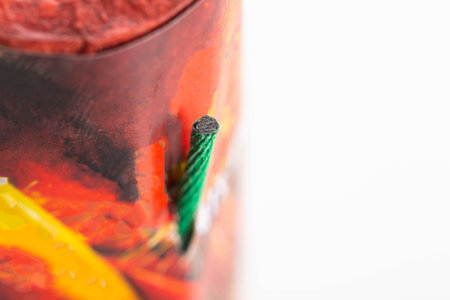 Flying firecracker fireworks with a wick on a white background, close-up. Copy space for text