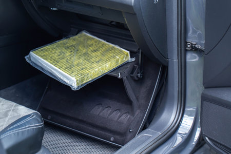 Replacement of a modern new anti-allergenic and antibacterial cabin filter in a carの写真素材