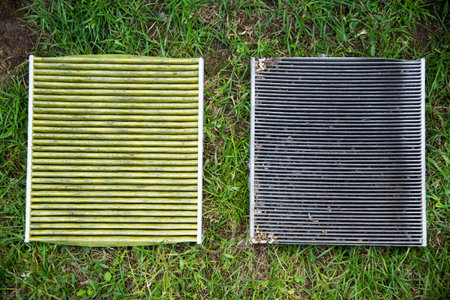 Old dirty and new modern clean cabin filter of the car. Concept of replacement of consumables in the...