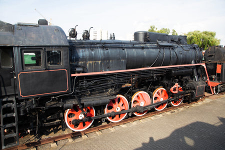 Black old steam locomotive at a museum exhibition