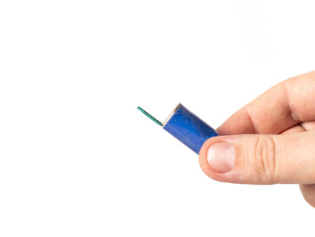 Firecracker with a wick in hand on a white background, isolate. Copy space for text