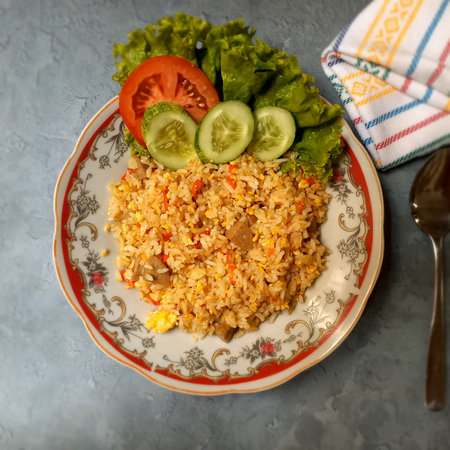Fried rice with vegetables on a plate. Selective focus.の写真素材