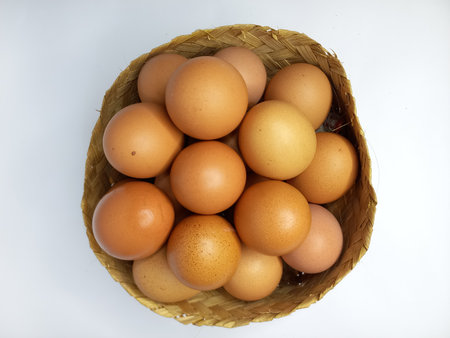 Eggs in a basket isolated on white background. Top view.の写真素材