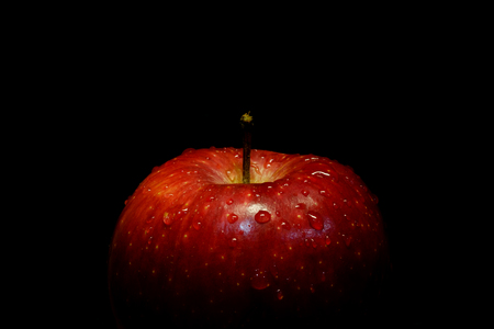 Red apple on black isolated backgroundの写真素材