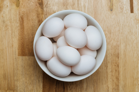 Chicken eggs in white bowlの写真素材