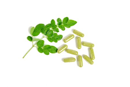 Moringa leaves and capsules on white backgroundの写真素材
