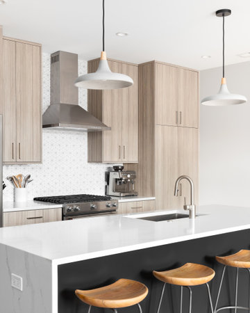 A beautiful, modern kitchen with a dark grey island with a white marble waterfall granite island,...
