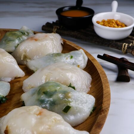 Close up fresh boiled dumplings with hot steams on wood plate.の写真素材