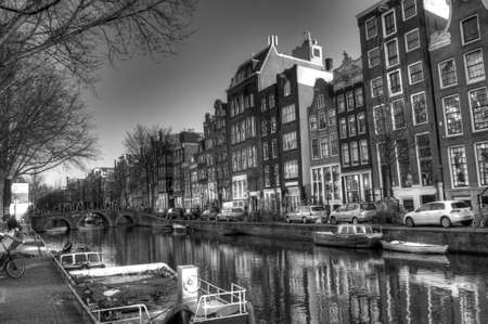 Amsterdam city houses, churches, buldings and canals. Live in the Netherlands in a dutch wayの写真素材