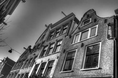 Amsterdam city houses, churches, buldings and canals. Live in the Netherlands in a dutch wayの写真素材