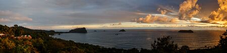 The coastline of the Pacific ocean at sunset in Manuel Antonio in Costa Rica made by different photos stitched together.の写真素材