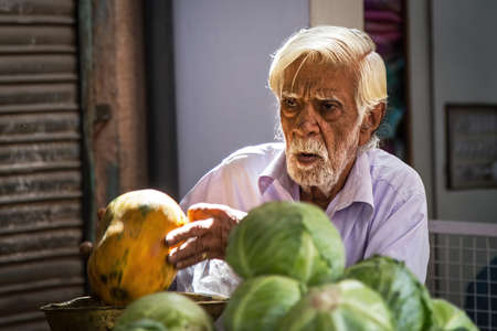 Jodhpur, Rajasthan, India - February 23, 2015: Portrait of an old man selling food on a market in...