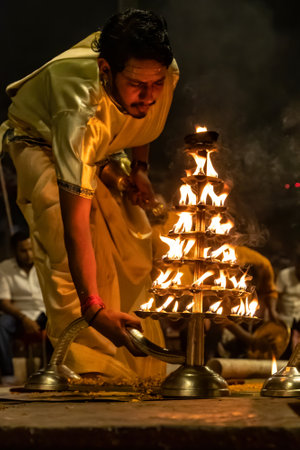Varanasi, Banaras, Uttar Pradesh, India - April 18, 2018 : Hindu priests perform an Arti worship...