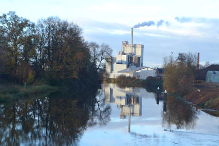 factory with smoking pipe near river Oude IJssel