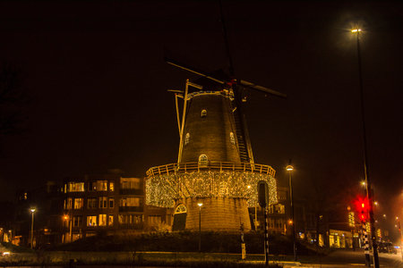 Traditional Dutch windmill in the old town of Rotterdam at nightの写真素材