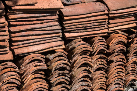 Old red clay tiles on the roof of a house in Thailand.の写真素材