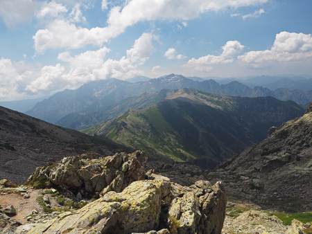 high mountain view scenery with the blue sky and clouds and green meadowの写真素材