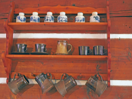 wooden shelve with potteries - hand made painted cups and spice jars and jugsの写真素材
