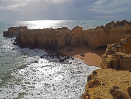 sea shore with beautiful beach and sandstone cliffsの写真素材