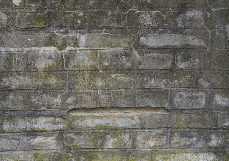 old concrete brick wall texture background -fissures and mossの写真素材