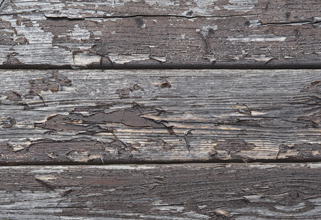 old planks fence with  peeling brown varnish texture - wall backgroundの写真素材