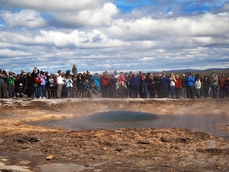 ICELAND, STROKKUR, JULY 26, 2016: bubble just before Strokkur geysir eruption Golden Circle, big group od colorful dressed tourist takeing pictures and waiting for fountain geyser to erupt. Strokkur is the most famous fountain geyser in Icelandのeditorial素材