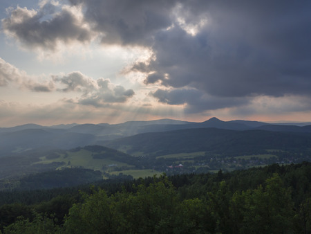Lusatian Mountains (luzicke hory) panorama,view from Hochwald (Hvozd) mountain on czech german borders with sun rays blue green hills forest and pink cloudy sunset sky backgroundの写真素材