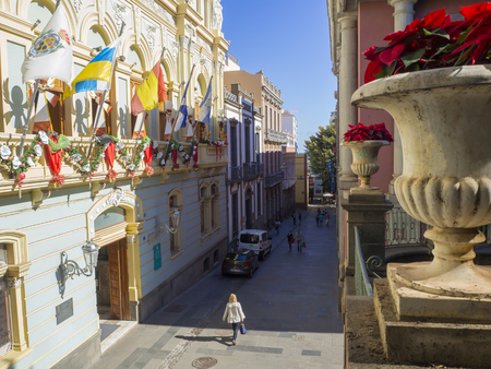 Spain, Canary islands, Santa Cruz de Tenerife, December 27, 2017: view on street in city center with christmas decoration, coloful garland and christmas star in flower potのeditorial素材