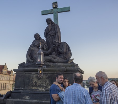 Czech Republic, Prague , September 8, 2018: Family takeing photo in front of Statue of Pieta in the...