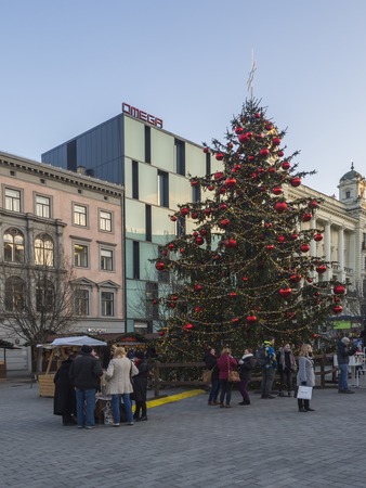 BRNO, CZECH REPUBLIC, DECEMBER 14, 2018: Decorated big christmas tree and market on Namesti Svobody, Market square with stand stall in Moravia capital city centre with shopping local and tourist people and christams decoration, late afternoonのeditorial素材