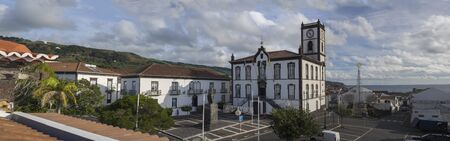 Portugal, VILA FRANCA DO CAMPO, Sao Miguel, Azores, December 28, 2018: Panoramic view on main square in the center of Vila Franca do Campo town with Town Hall with clock tower in colonial style and christmas decoration with sea and green hills, morning blのeditorial素材